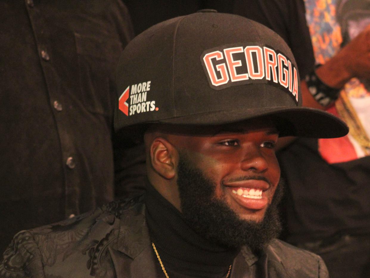 Westside High School defensive tackle Jordan Hall dons an oversized Georgia hat during his college football signing ceremony on Wednesday.