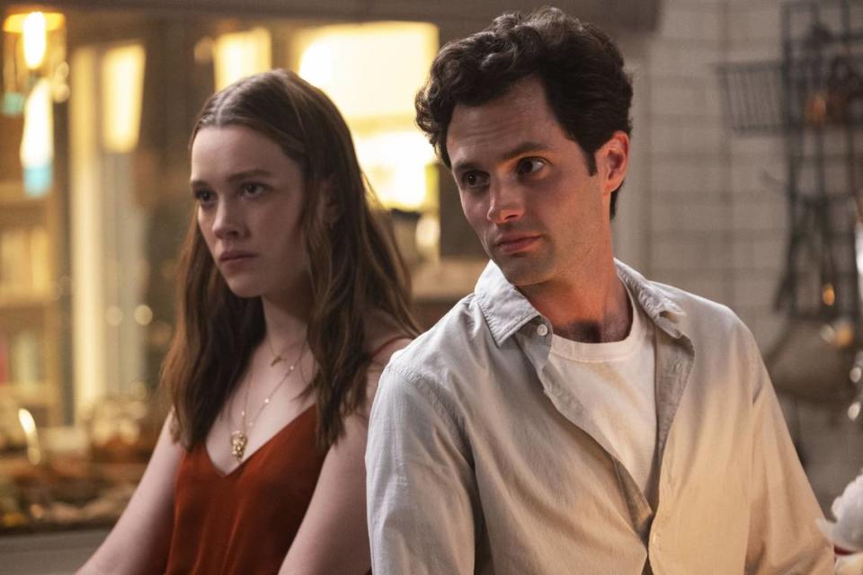 Victoria Pedretti, left, and Penn Badgley appear in a scene from “You” on Netflix.