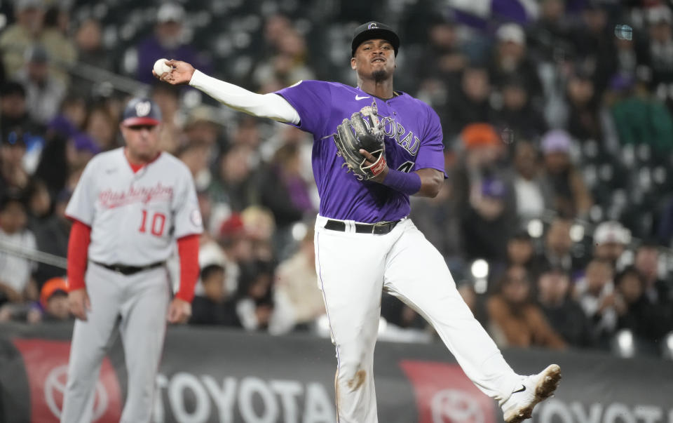 Colorado Rockies third baseman Elehuris Montero throws to first base on a single hit by Washington Nationals' Victor Robles in the ninth inning of a baseball game Friday, April 7, 2023, in Denver. (AP Photo/David Zalubowski)