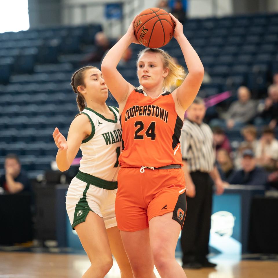 Cooperstown's Savannah Kirkby passes the ball inside SRC Arena Saturday. Cooperstown defeated Weedsport 64-59 and secured Section III's 2022-23 Class C championship.