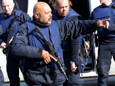 Police at the scene where shots were fired during a police search of a house in the suburb of Forest near Brussels, Belgium, March 15, 2016. REUTERS/Francois Lenoir