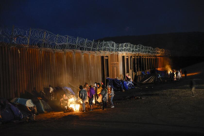 Jacumba, CA, Friday, November 24, 2023 - Asylum seekers from China, Colombia and the Middle East camp near the border wall, often waiting days to be transported by the U.S. Border Patrol. (Robert Gauthier/Los Angeles Times)