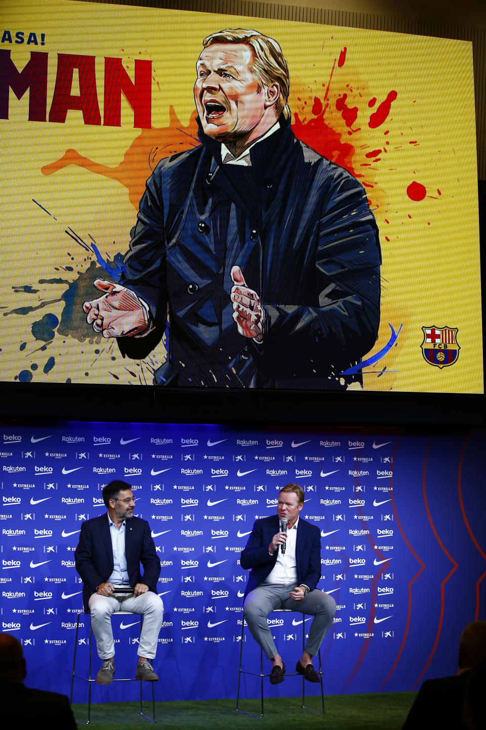 Ronald Koeman, right, speaks next to club Director Josep Bartome during his official presentation as coach for FC Barcelona in Barcelona, Spain, Wednesday, Aug. 19, 2020. Barcelona officially announced earlier on Wednesday a deal with Koeman to become their coach five days after the team's humiliating 8-2 loss to Bayern Munich in the Champions League quarterfinals. Barcelona says the former defender's deal runs through June 2022. Koeman replaces the fired Quique Setien. (AP Photo/Joan Monfort)