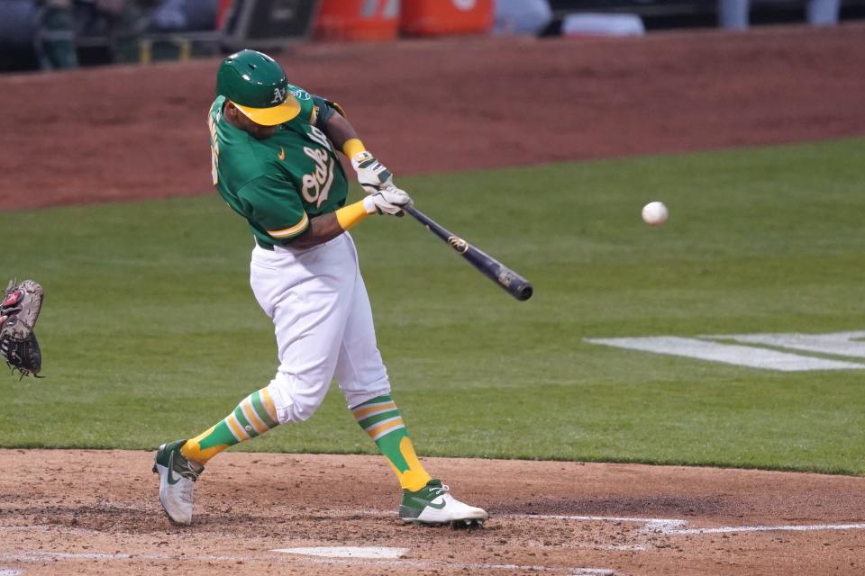 Oakland Athletics designated hitter Khris Davis (2) hits a double during the fourth inning against the Arizona Diamondbacks at Oakland Coliseum in Oakland, California on August 20, 2020.