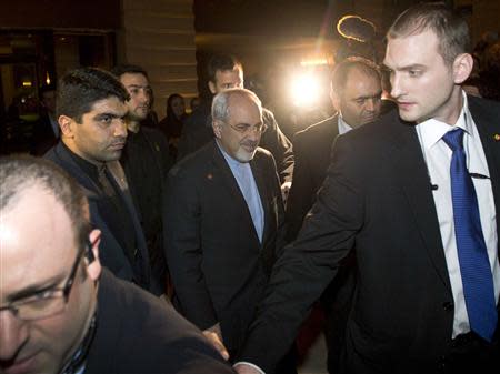 Iranian Foreign Minister Mohammad Javad Zarif (C) arrives at his hotel in Geneva November 8, 2013, following his meeting with U.S. Secretary of State John Kerry and European Union foreign policy chief Catherine Ashton. REUTERS/Jason Reed