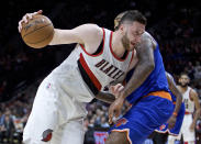 FILE - In this March 23, 2017, file photo, Portland Trail Blazers center Jusuf Nurkic, left, drives past New York Knicks center Kyle O'Quinn during the second half of an NBA basketball game in Portland, Ore. His arrival sparked the lackluster Trail Blazers and he quickly became a fan favorite in Portland. Now Rip City anxioulsy waits to see when _ and if _ big man Jusuf Nurkic will return for the playoffs.(AP Photo/Craig Mitchelldyer, File)