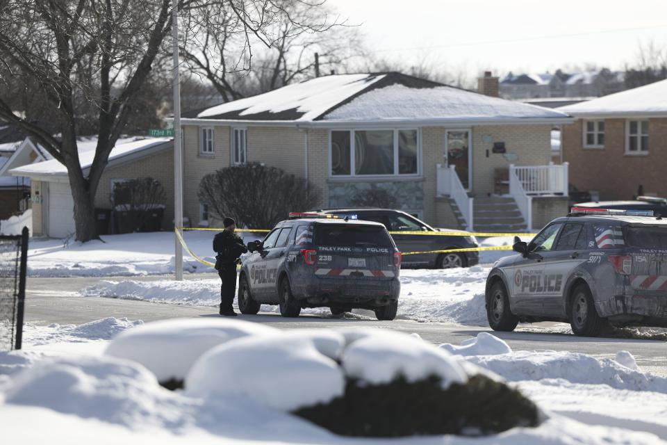 FILE - Police work at the scene of a shooting in Tinley Park on Sunday, Jan. 21, 2024. Murder charges were filed Tuesday, Jan. 23, 2024 against a suburban Chicago man accused of killing his wife and three adult daughters in what police have described as a domestic-related shooting. (Eileen T. Meslar/Chicago Tribune via AP, file)
