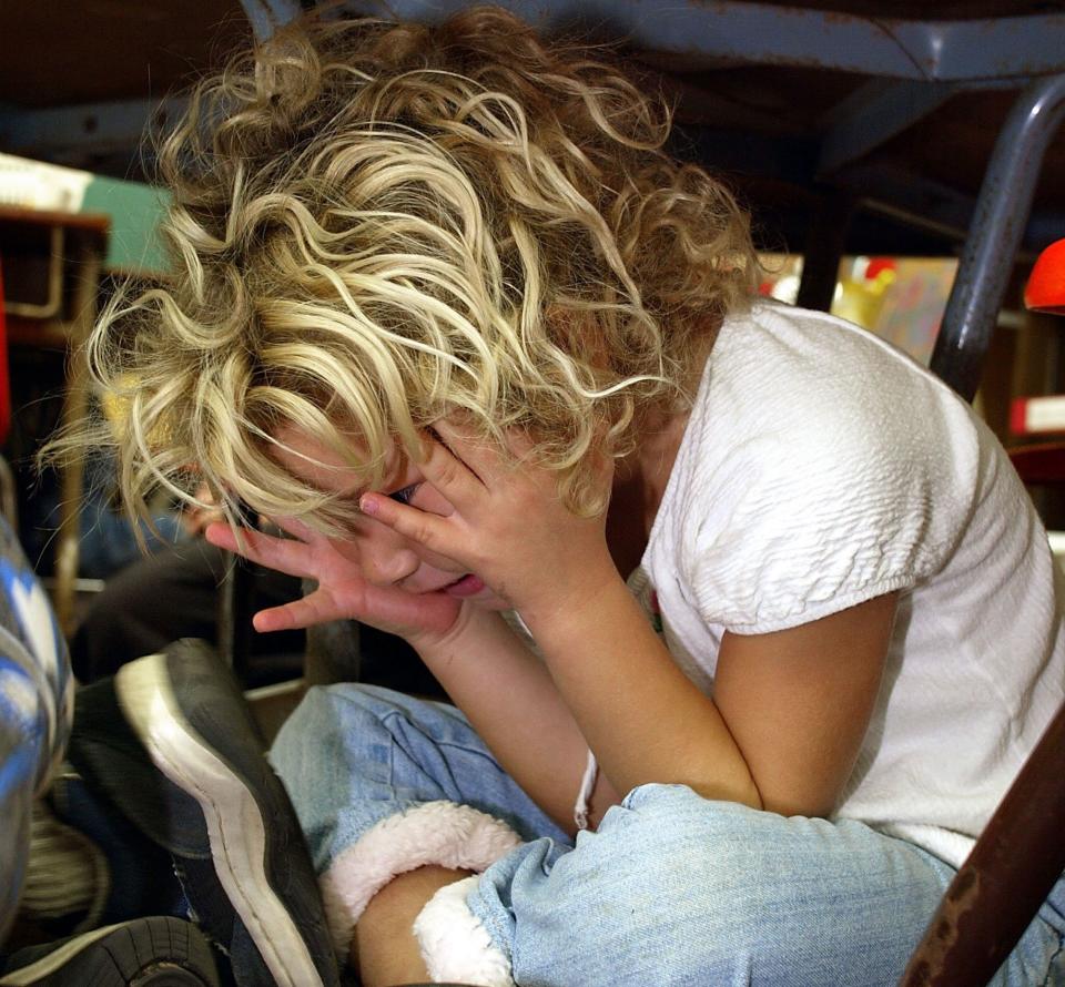 A kindergarten student during a lockdown drill in 2003. With increased school security comes concerns about the psychological toll on young people. (Photo: Phil Mislinski via Getty Images)