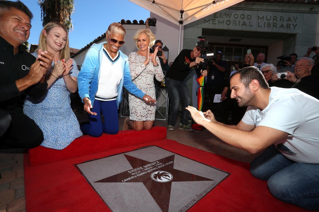 Recording artist Dionne Warwick, third from left, receives the 447th entry to The Walk of Stars Palm Springs in downtown Palm Springs, Calif., on December 8, 2021. Oscar's Palm Springs owner Dan Gore, left, Palm Springs Mayor Christy Holstege and Palm Springs Chamber of Commerce CEO Nona Watson applaud Warwick. 