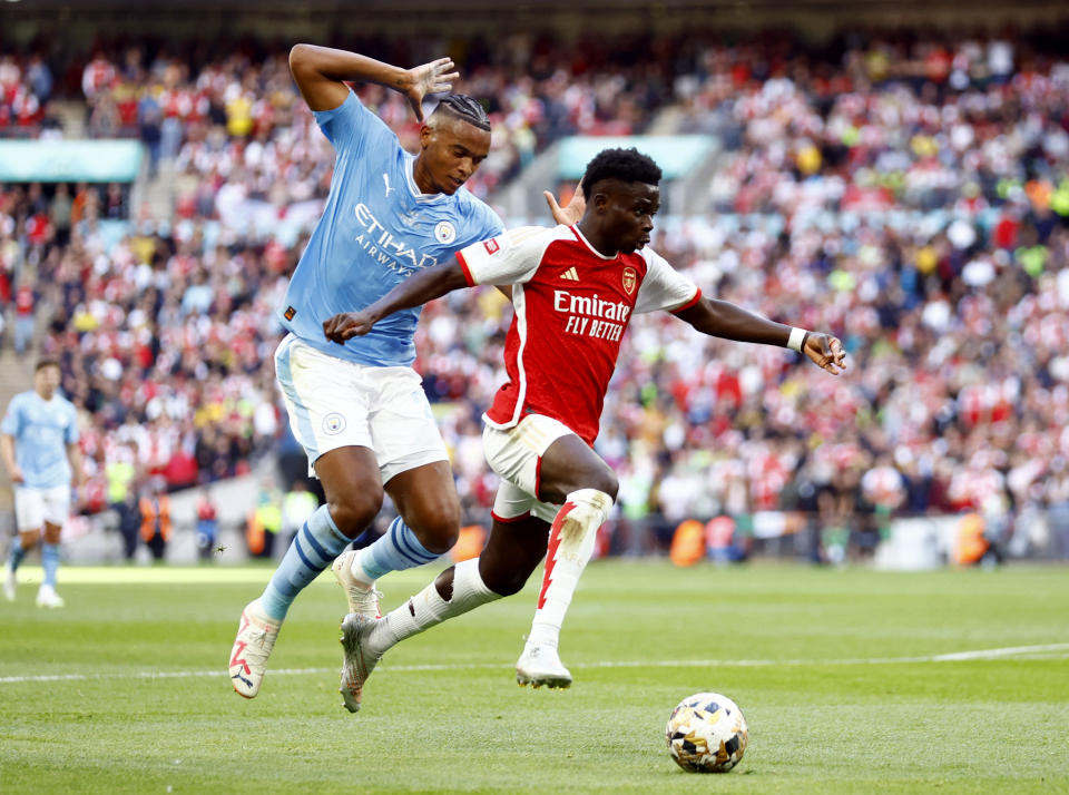 Arsenal's Bukayo Saka (right) in action with Manchester City's Manuel Akanji during their Community Shield match.
