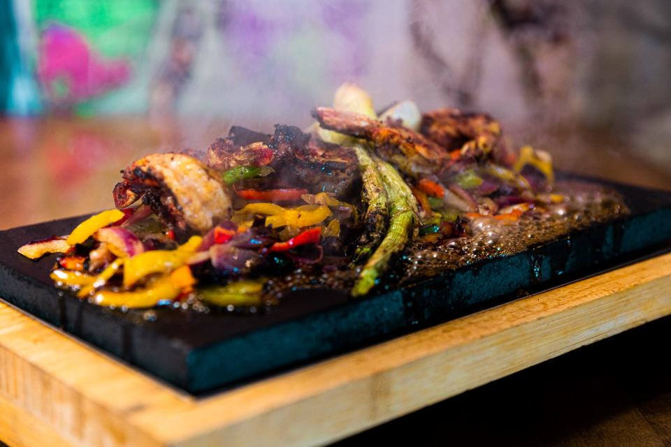 The carne asada and shrimp lava rock fajitas at The Mexicano.