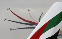 Al Fursan, the aerobatics demonstration team of the United Arab Emirates Air Force, performs during the Dubai Airshow November 17, 2013. REUTERS/Ahmed Jadallah