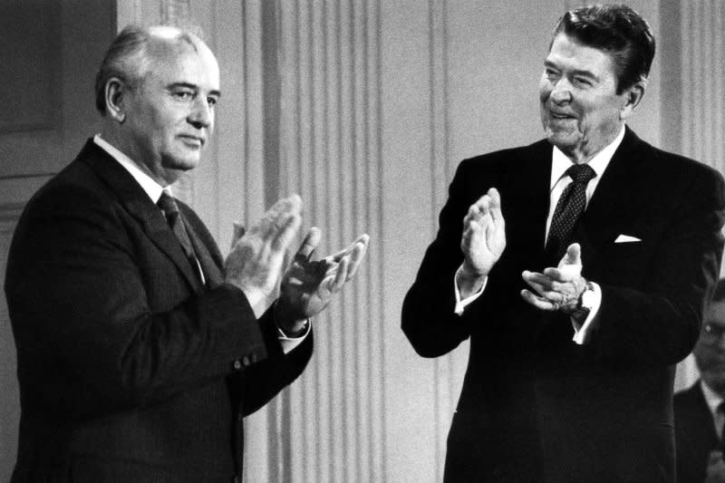 President Ronald Reagan (R) and Soviet leader Mikhail Gorbachev applaud after signing the historic arms control agreement banning intermediate-range nuclear missiles in the East Room of the White House on December 8, 1987. UPI File Photo