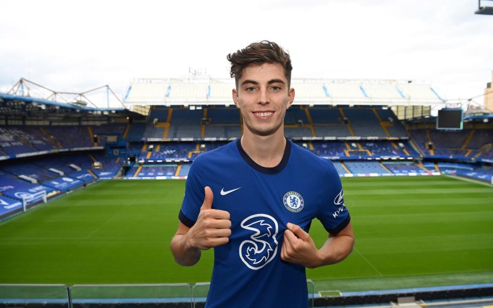 Kai Havertz wearing the Chelsea home shirt poses for the camera as Chelsea - Getty Images