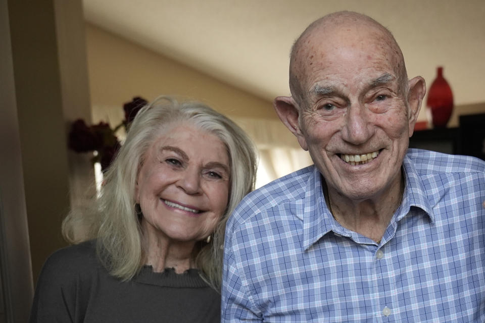 World War II veteran Harold Terens, 100, right, and Jeanne Swerlin, 96, pose for a photo, Thursday, Feb. 29, 2024, in Boca Raton, Fla. Terens will be honored by France as part of the country's 80th anniversary celebration of D-Day. In addition, the couple will be married on June 8 at a chapel near the beaches where U.S. forces landed. (AP Photo/Wilfredo Lee)