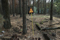 <p>A sign warns of radiation contamination in a forest in the abandoned city of Pripyat near the Chernobyl nuclear power plant on Aug. 18, 2017, in Pripyat, Ukraine. (Photo: Sean Gallup/Getty Images) </p>