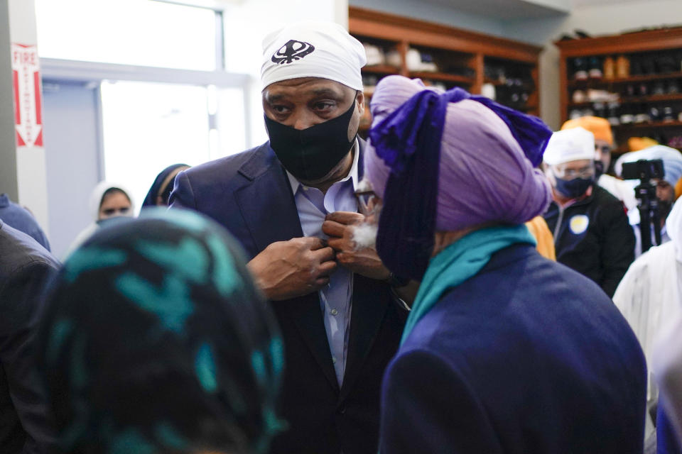 Rep. Andre Carson, D-Ind., speaks with members of the Sikh Coalition at the Sikh Satsang of Indianapolis in Indianapolis, Saturday, April 17, 2021, for a commemoration of the victims of the shooting at a FedEx facility in Indianapolis that claimed the lives of four members of the Sikh community. A gunman killed eight people and wounded several others before taking his own life in a late-night attack at a FedEx facility near the Indianapolis airport. (AP Photo/AJ Mast)