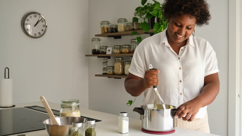 woman hand-mashing potatoes