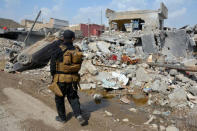 A member of the Counter Terrorism Service (CTS) walks at the site after an air strike attack against Islamic State triggered a massive explosion in Mosul, Iraq March 29, 2017. REUTERS/Stringer FOR EDITORIAL USE ONLY. NO RESALES. NO ARCHIVES.