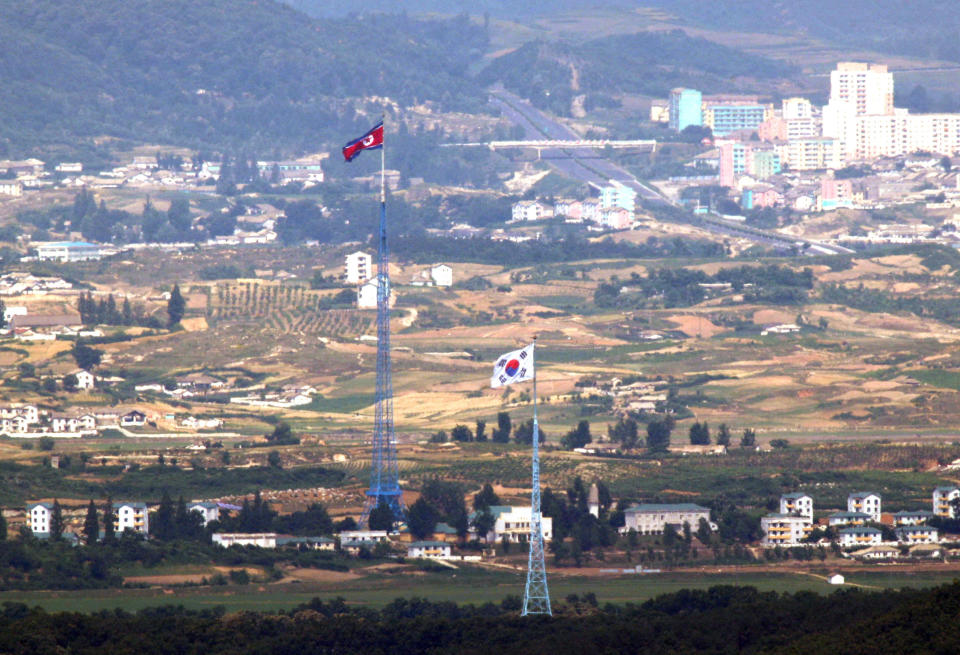 Flags of North Korea, rear, and South Korea, front, flutter in the wind in this photo taken from Paju, South Korea, Friday, June 19, 2020. The North in recent months has virtually cut off all cooperation with the South while expressing frustration over Seoul’s unwillingness to break away from ally Washington and restart inter-Korean economic projects held back by U.S.-led sanctions over its nuclear weapons program. (Seoul Myung-gon/Yonhap via AP)