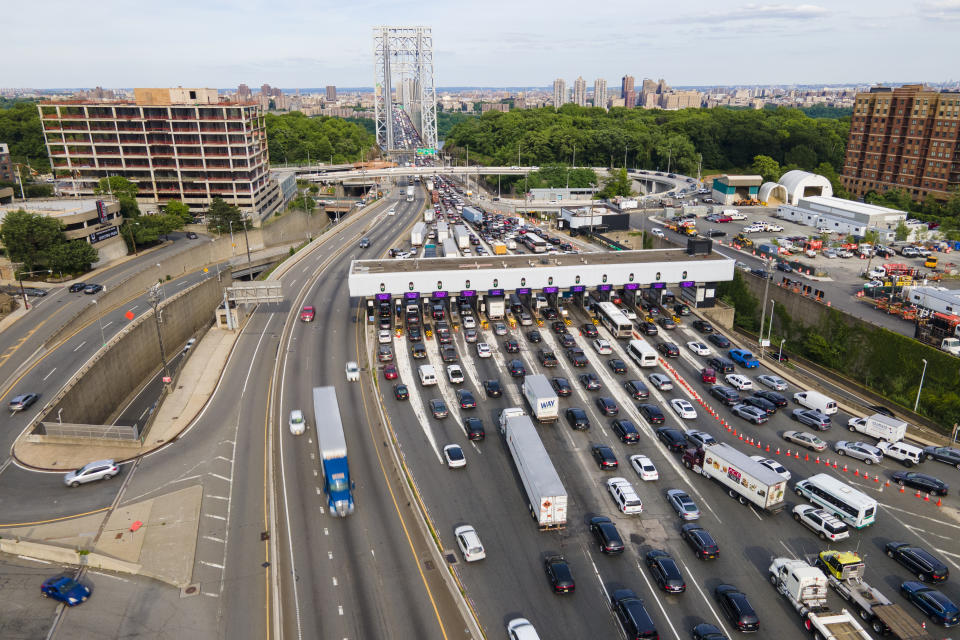 FILE - Traffic passes through the toll plaza at the George Washington Bridge in Fort Lee, New Jersey, on Friday, June 10, 2022. The rate of people working from home dropped from 17.9% in 2021 to 15.2% in 2022, according to new survey data released Thursday, Sept. 14, 2023, by the U.S. Census Bureau on life in America, covering commuting times internet access, family life, income, education levels, disabilities, military service and employment. (AP Photo/Ted Shaffrey, file)