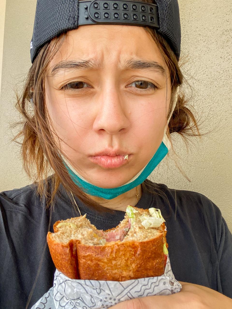 The author takes a bite of her Publix sub.