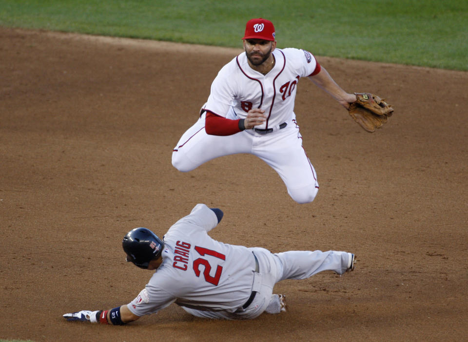 Washington Nationals second baseman Danny Espinosa tries for a double play as St. Louis Cardinals' Allen Craig (21) slides safely into second base during the sixth inning in Game 4 of their MLB NLDS baseball series in Washington October 11, 2012. REUTERS/Jonathan Ernst (UNITED STATES - Tags: SPORT BASEBALL TPX IMAGES OF THE DAY)