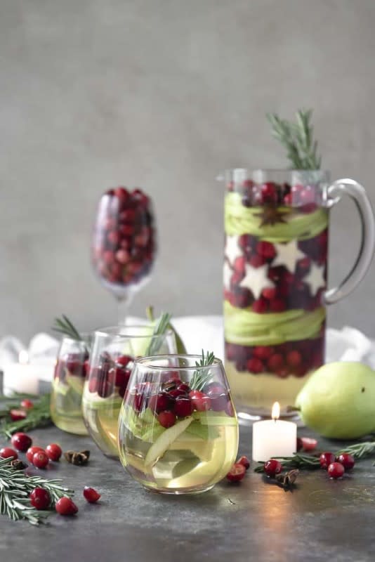 <p>The Crumbly Kitchen</p><p>White wine, ginger beer, pear brandy and some festive red and green fruit are all you need for this show stopper drink.</p><p><strong>Get The Recipe: <a href="https://thecrumbykitchen.com/white-christmas-sangria/" rel="nofollow noopener" target="_blank" data-ylk="slk:White Christmas Sangria;elm:context_link;itc:0;sec:content-canvas" class="link ">White Christmas Sangria</a></strong></p>