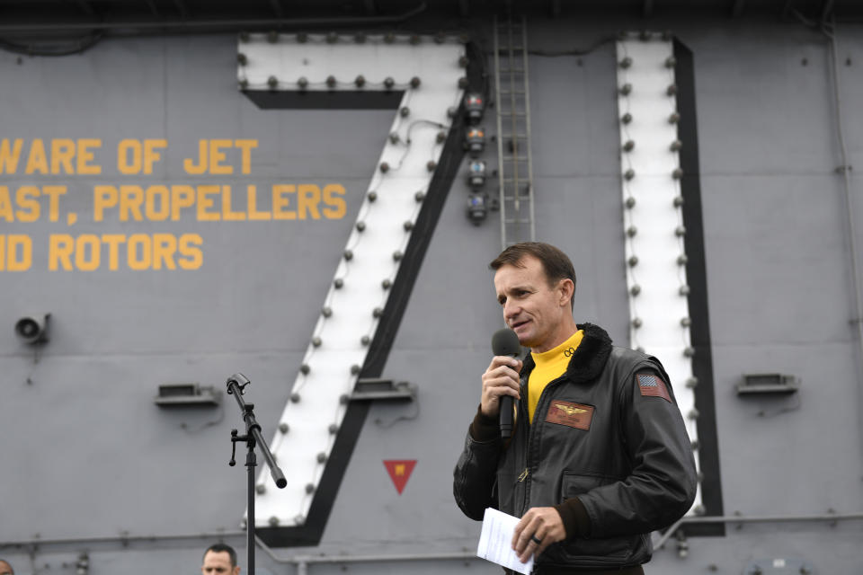 U.S. Navy Capt. Brett Crozier, then commanding officer of the aircraft carrier USS Theodore Roosevelt (CVN 71), addresses the crew during an all-hands call on the ship's flight deck while conducting routine operations in the Eastern Pacific Ocean in Nove. 2019.  (Mass Communication Specialist 3rd Class Nicholas Huynh/U.S. Navy via AP)