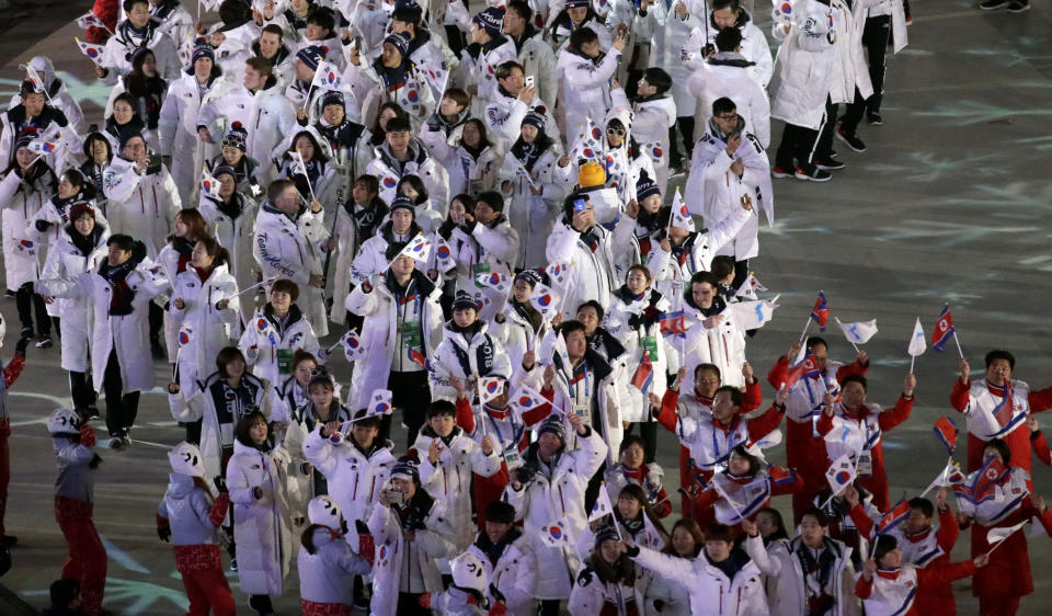 North Korean athletes, bottom right, walk ahead of South Korean athletes as they march into the stadium during the closing ceremony of the 2018 Winter Olympics in Pyeongchang, South Korea, Sunday, Feb. 25, 2018. (AP Photo/Aaron Favila)