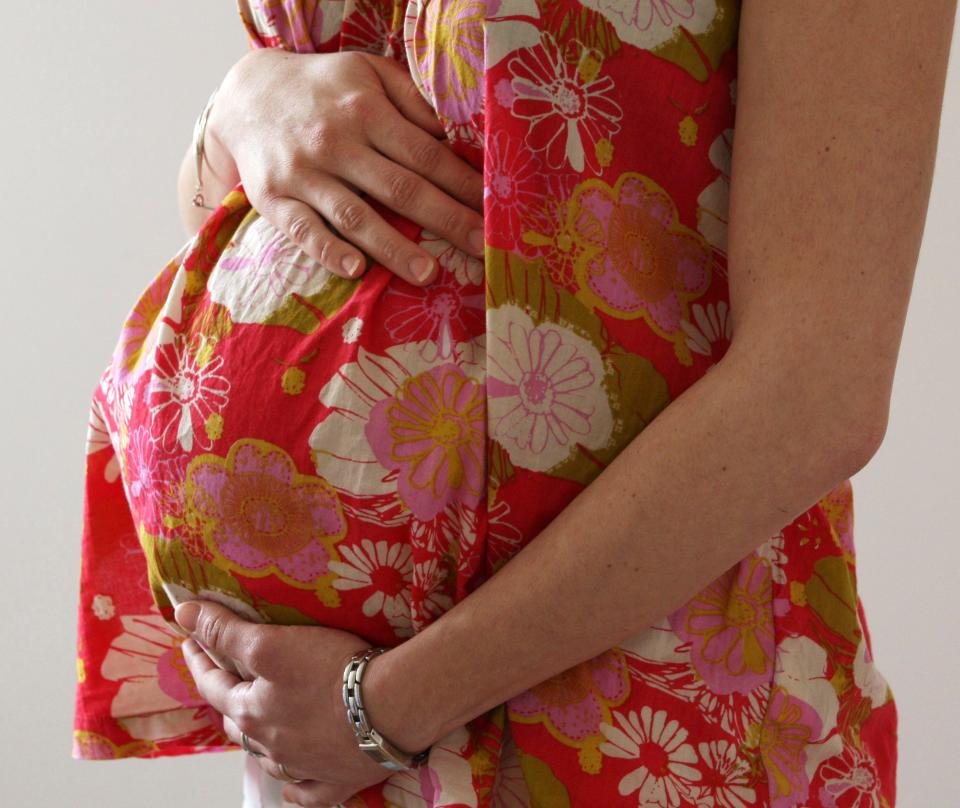 FILE PHOTO: A woman holds her stomach at the last stages of her pregnancy in Bordeaux April 28, 2010.  REUTERS/Regis Duvignau/File Photo