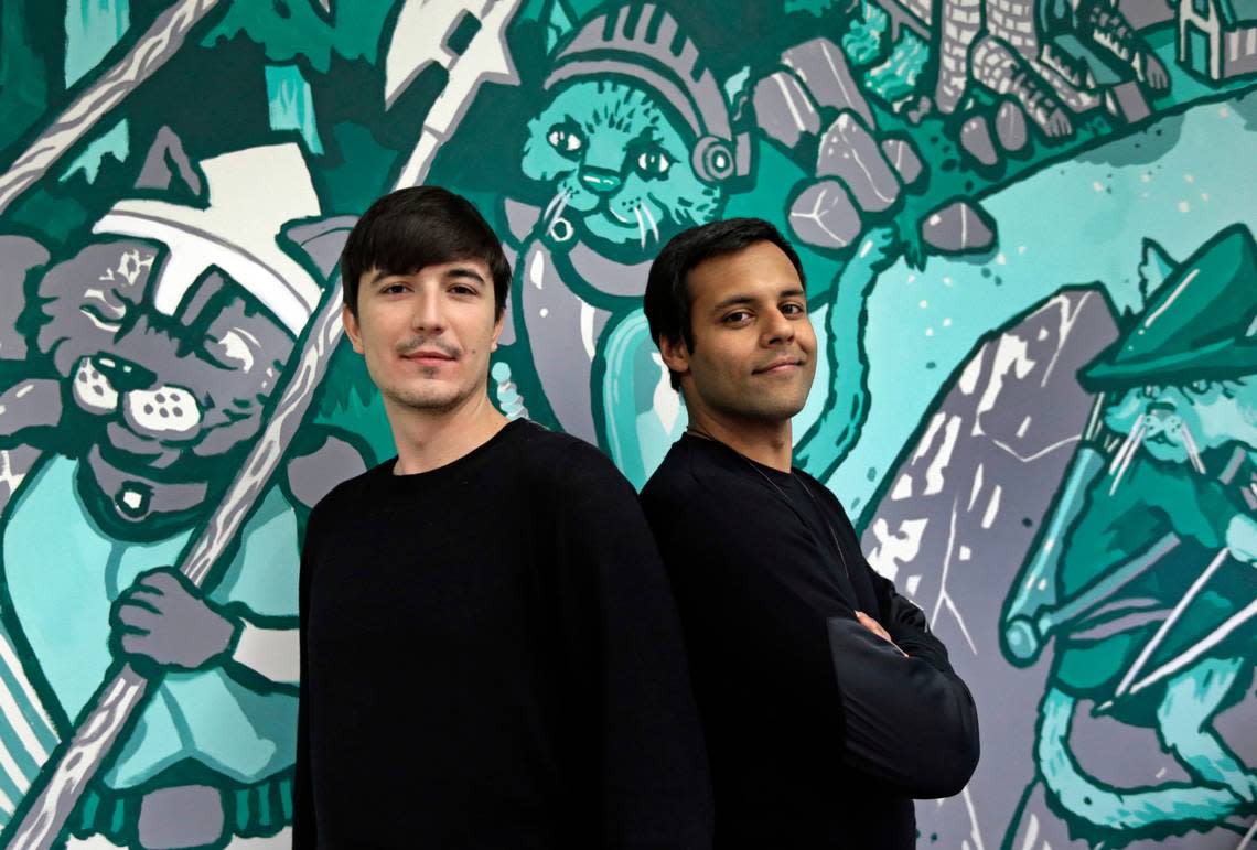 In this Wednesday, Dec. 2, 2015, photo, Robinhood co-founders Vlad Tenev, left, and Baiju Bhatt pose at company headquarters in Palo Alto, Calif. Robinhood is a stock brokerage that does not charge any commissions for its more than 1 million customers to buy and sell shares. “During the next 10 years, we are going to create an international company that will be like nothing the financial services industry has ever seen,” says Bhatt.