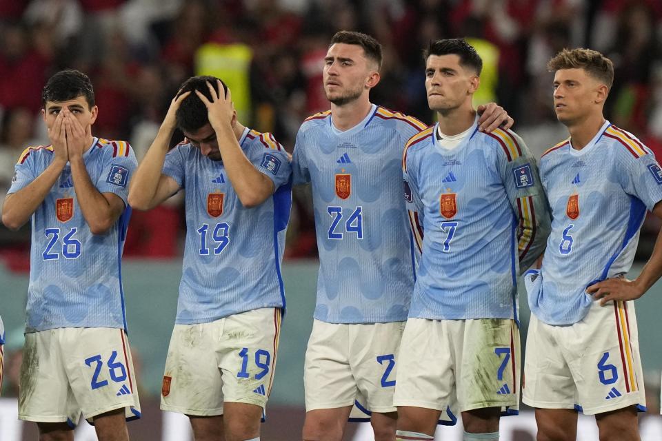 Spain's Pedri, from left, Carlos Soler, Aymeric Laporte, Alvaro Morata and Marcos Llorente react after the penalty shootout at the World Cup round of 16 soccer match between Morocco and Spain, at the Education City Stadium in Al Rayyan, Qatar, Tuesday, Dec. 6, 2022. (AP Photo/Luca Bruno)