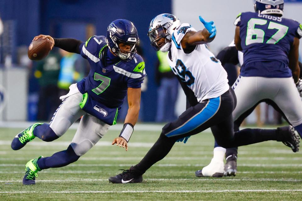 Carolina Panthers defensive end Marquis Haynes Sr. (98) sacks Seattle Seahawks quarterback Geno Smith (7) during the fourth quarter at Lumen Field.