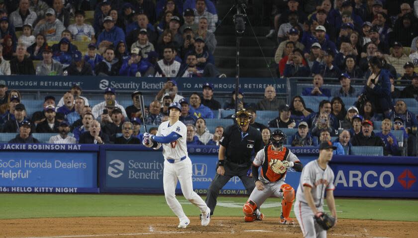 Los Angeles, CA - April 03: Dodgers designated hitter Shohei Ohtani, #17, hits his first home run as a Dodger off of Giants pitcher Taylor Rogers, # 33, in the seventh inning at Dodger Stadium in Los Angeles Wednesday, April 3, 2024. (Allen J. Schaben / Los Angeles Times)