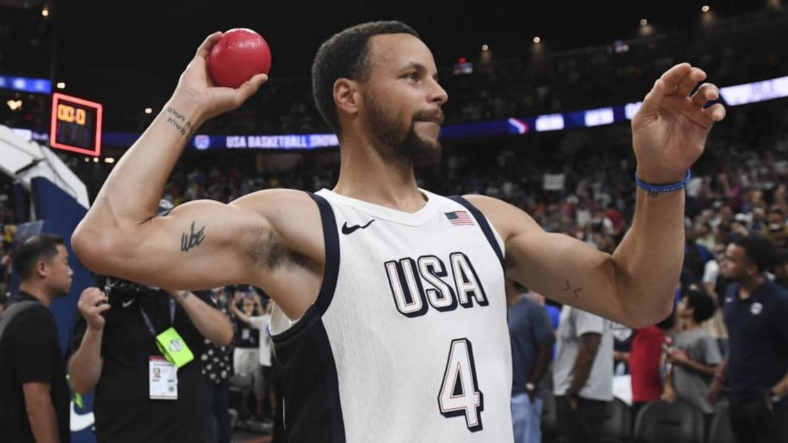 Steph Curry throws a ball to fans after defeating Canada in the USA Basketball Showcase at T-Mobile Arena.