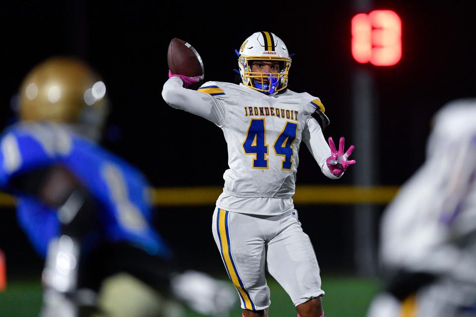 Irondequoit's Isaiah Ballard looks downfield as he throws a touchdown pass to Steven Clinkscales during a regular season game against Webster Schroeder, Friday, Oct. 13, 2023.