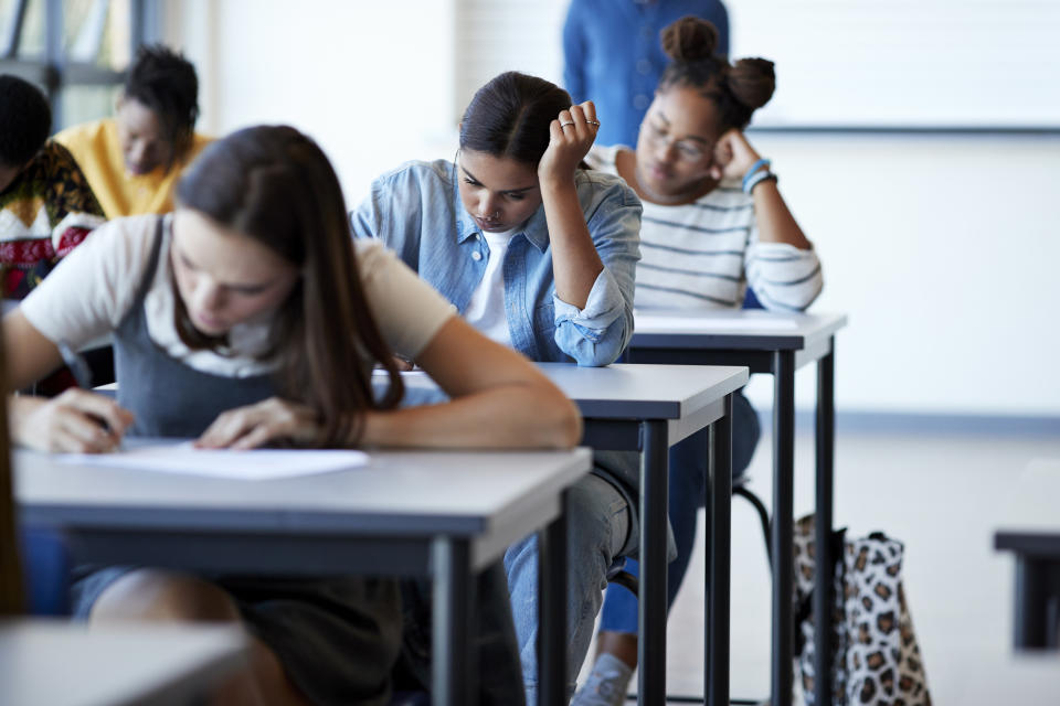 A row of students taking a test in a classroom