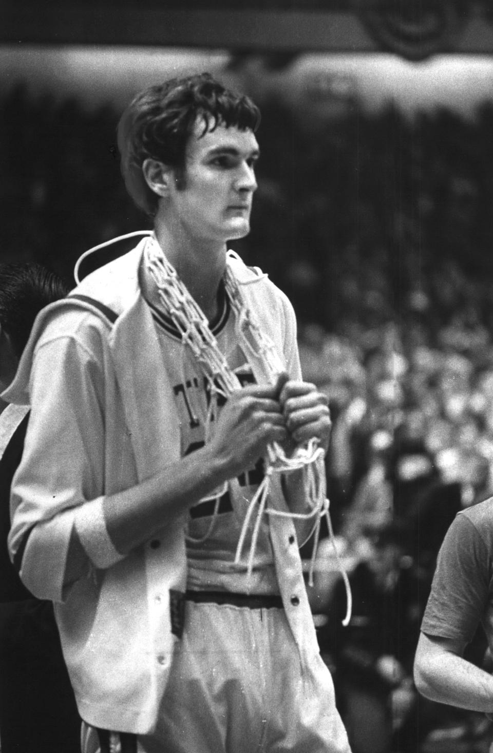 Tom Burleson, North Carolina State's 7 foot 4 inch center had the net draped around his neck after the Wolfpack defeated Marquette for the National Collegiate Athletic Association Basketball tournament title on March 25, 1974, at Greensboro, NC., 76-64.