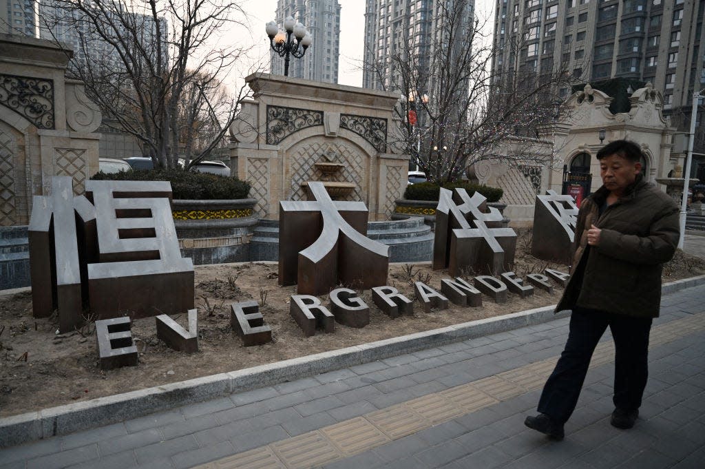 A man walks past an Evergrande Group residential complex called Evergrande Palace in Beijing on January 29, 2024.