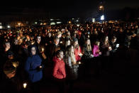 People gather for a candlelight vigil for the Haynie family at City Park in Grantsville, Utah, Monday, Jan. 20, 2020. Police say four members of the Haynie family were killed and one injured after being shot by a teenage family member on Jan. 17. (Spenser Heaps/The Deseret News via AP)