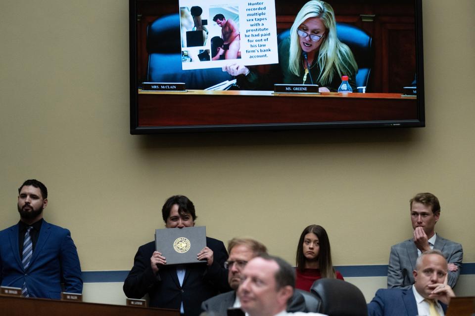 People watch as US Representative Marjorie Taylor Greene, R-Ga., holds up a graphic photo of Hunter Biden during the House Committee on Oversight and Accountability hearing regarding the criminal investigation into the Bidens, on Capitol Hill in Washington, D.C., on July 19, 2023.