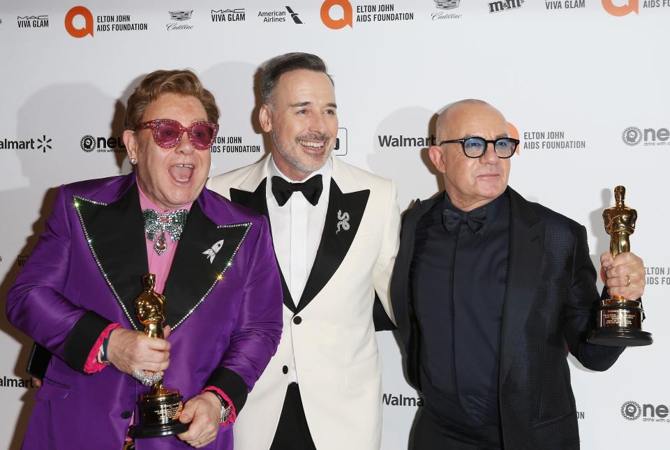 Sir Elton John, left, husband David Furnish and songwriter Bernie Taupin after the Oscars earlier this year. John and Taupin took home best original song for "(I'm Gonna) Love Me Again" from John's biopic "Rocketman."