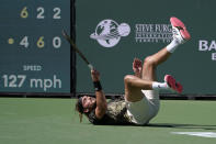 Stefanos Tsitsipas, of Greece, takes a tumble during his match against Nikoloz Basilashvili, of Georgia, at the BNP Paribas Open tennis tournament Friday, Oct. 15, 2021, in Indian Wells, Calif. (AP Photo/Mark J. Terrill)