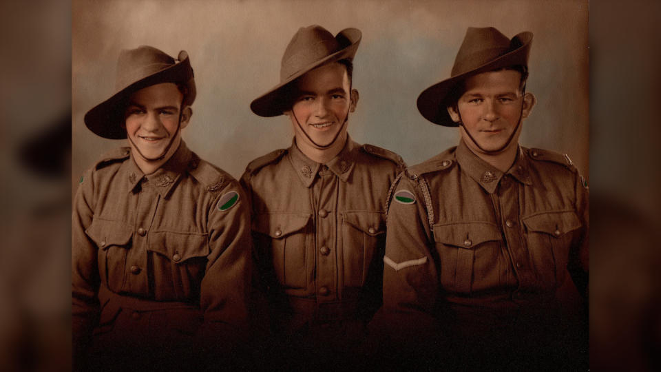 A WWII photo of three brothers from Australia smiling together and dressed in uniform. They all perished in the shipwreck.