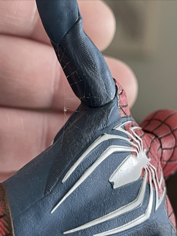 Close-up of a Spider-Man figurine showcasing intricate webbing details on its suit