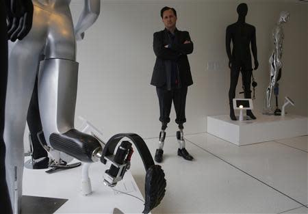 Professor Hugh Herr, who heads the Biomechatronics research group at the MIT Media Lab, stands amid mannequins displaying various bionic limbs his lab has developed at the Massachusetts Institute of Technology in Cambridge, Massachusetts April 4, 2014. REUTERS/Brian Snyder