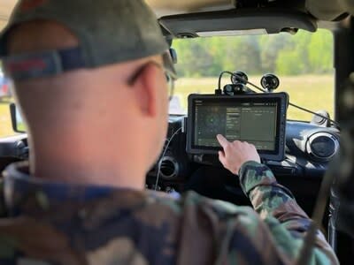 Operator with the tablet console of DroneShield DroneSentry-X vehicle counterdrone system