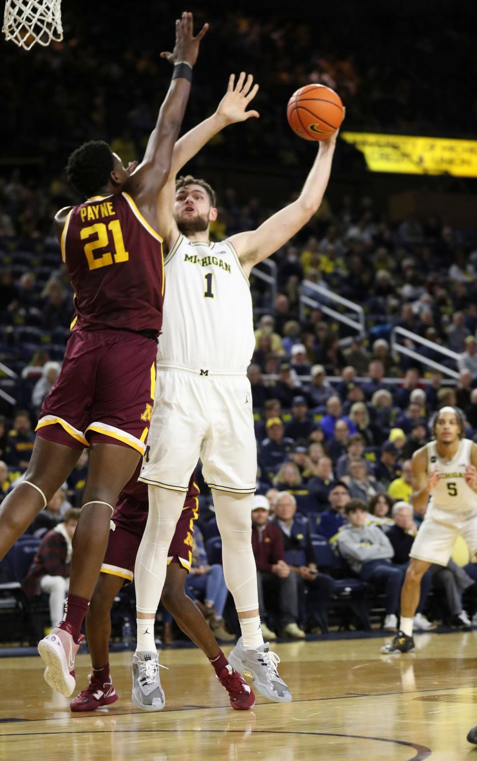 Michigan Wolverines center Hunter Dickinson (1) shoots against Minnesota Golden Gophers forward Pharrel Payne (21) during first half action at Crisler Center Sunday, January 22, 2023.