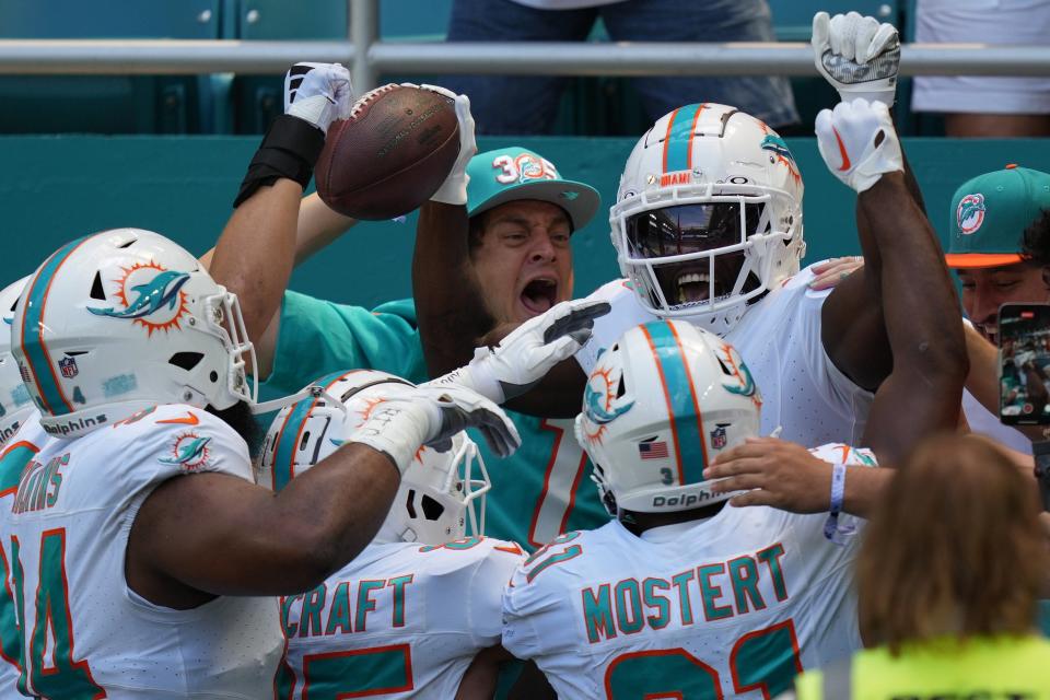 Miami Dolphins wide receiver Tyreek Hill (10) celebrates scoring a touchdown against the Denver Broncos during the first half of an NFL game from the stands at Hard Rock Stadium in Miami Gardens, Sept. 24, 2023.